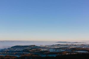 Aerial view of foggy mountains and blue sky photo