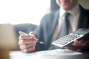 Businessman showing calculations at work photo