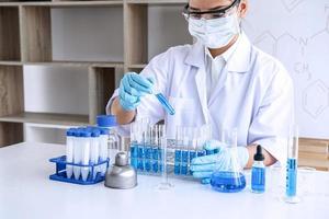 Chemist is analyzing sample in laboratory  photo
