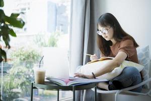 Teen girl using computer laptop to self learning online photo