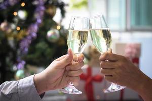 Two people clinking champagne glasses in celebration photo