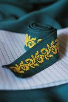 Cross stitch ethnic ornate on turquoise ribbon photo