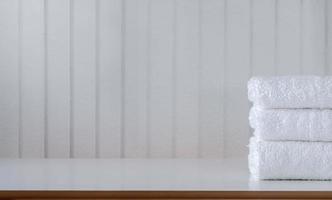 Stack of folded white towels on a table photo