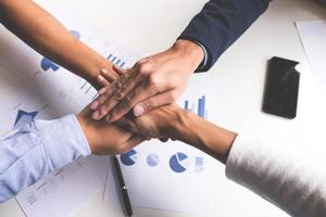 Close-up of business team joining hands photo
