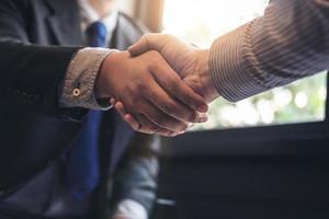 Close-up of two businessmen shaking hands photo