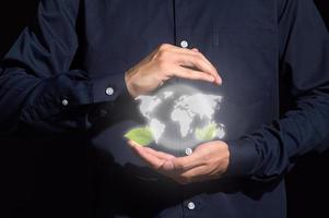 Human hands holding digital mockup of Earth photo