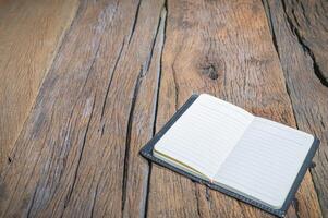 Notebook on a wooden table photo