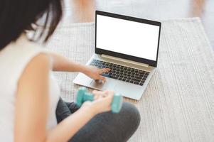 Woman using laptop for fitness photo