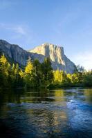 River with trees and mountain in background photo