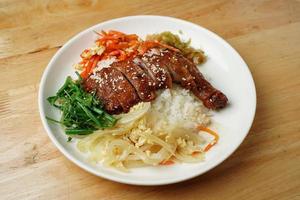 Meat with sesame seeds and rice photo