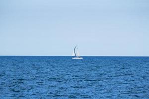 White sailboat in the ocean photo