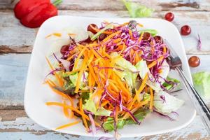 Vegetable salad on wooden table photo