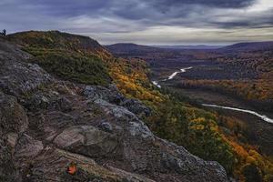 River flowing through valley at sunset photo