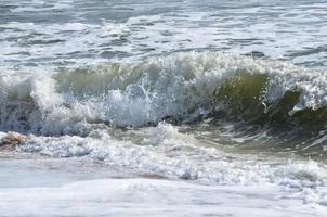 Waves crashing at the beach photo