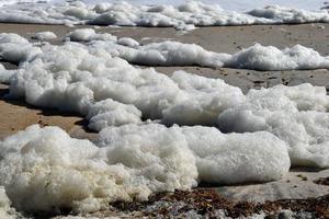 Ocean foam on the beach photo