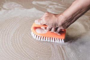 Close-up of person scrubbing a floor photo
