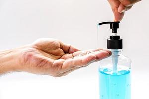 Close-up of a person sanitizing their hands photo
