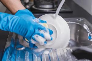 Close-up of a person washing dishes photo