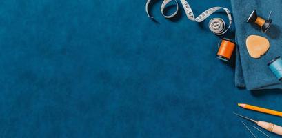 Blue textured background with sewing tools photo