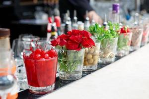 Cherries, herbs and flowers on bar counter photo