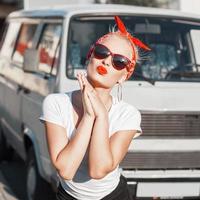 Beautiful girl with sunglasses and a red armband. Pin-Up Style. photo