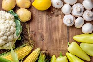The multicolored vegetables on wooden table photo