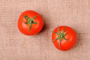 Tomatoes on a sackcloth background photo
