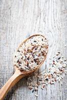 Rice on a wooden spoon close up photo