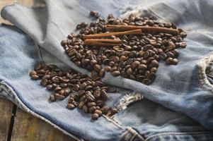 Coffee beans and Jeans on wood table photo