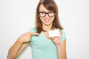 Young woman holding business card isolated on white background. photo