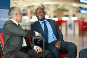 business travellers handshaking at airport