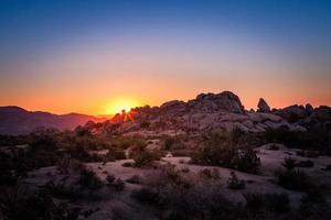 Sun Rise Over Boulder Formation In Joshua Tree National Park photo