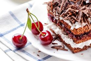 Black Forest cake piece with cherries berries photo