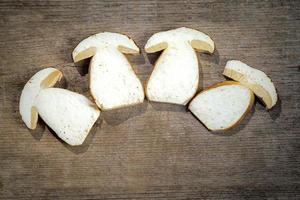 Fresh slices of Boletus Edilus mushrooms on a wooden table photo