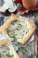 Puff pastry tarts with forest mushrooms, onion and thyme photo