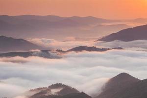 Amazing mountain landscape with dense fog. Carpathian Mountains. photo