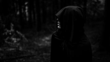 Demon in forest. Grim reaper in search of his victim. photo
