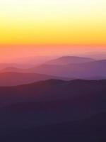 mountain peaks at sunset haze photo
