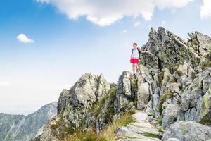 Young woman climbing high mountains