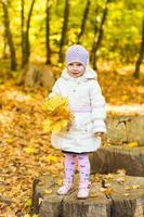 Little girl with yellow leaf