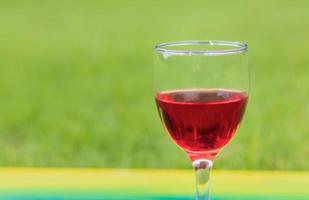 Red wine with green background photo