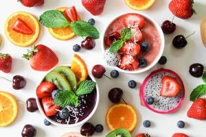 Fruits and smoothie on white surface photo