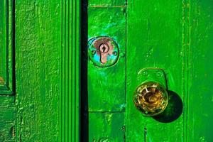 Door knob made of glass, retro doorway painted in green