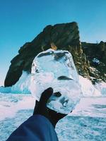 Person holding ball of ice photo