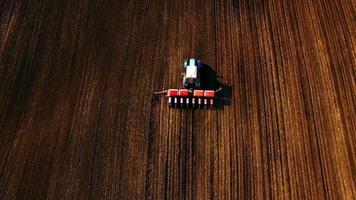 Aerial view of tractor sows sunflower video