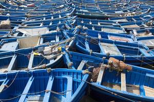 Blue fishing boats aligned in Essaouira
