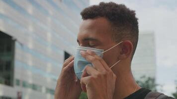 Slow motion of young man adjusting protective face mask video