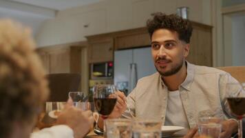 Family sitting down for dinner together video