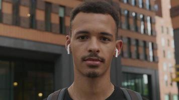 Slow motion of young man wearing wireless ear pods video