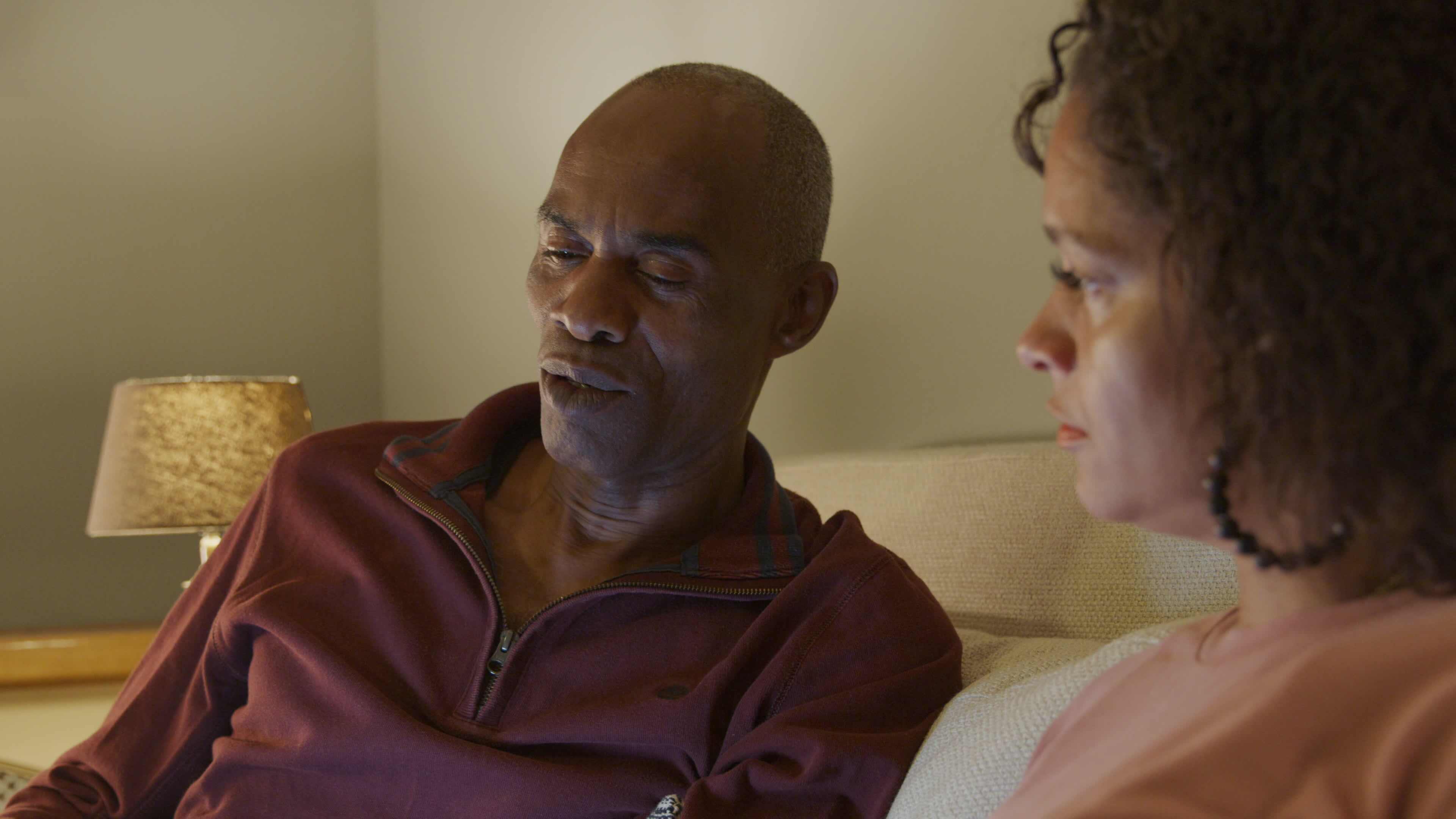 Mature couple relaxing on sofa at home
